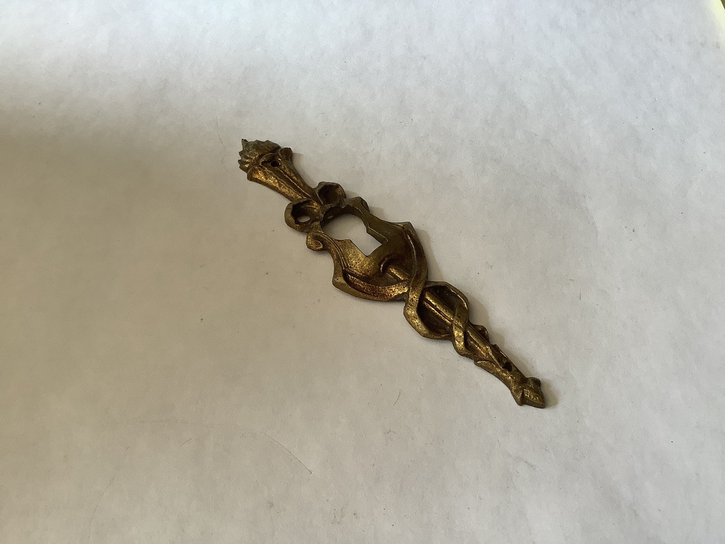 One Antique Brass Ormolu Keyhole Cover Escutcheon made in France in the 1920s elegant torch insignia