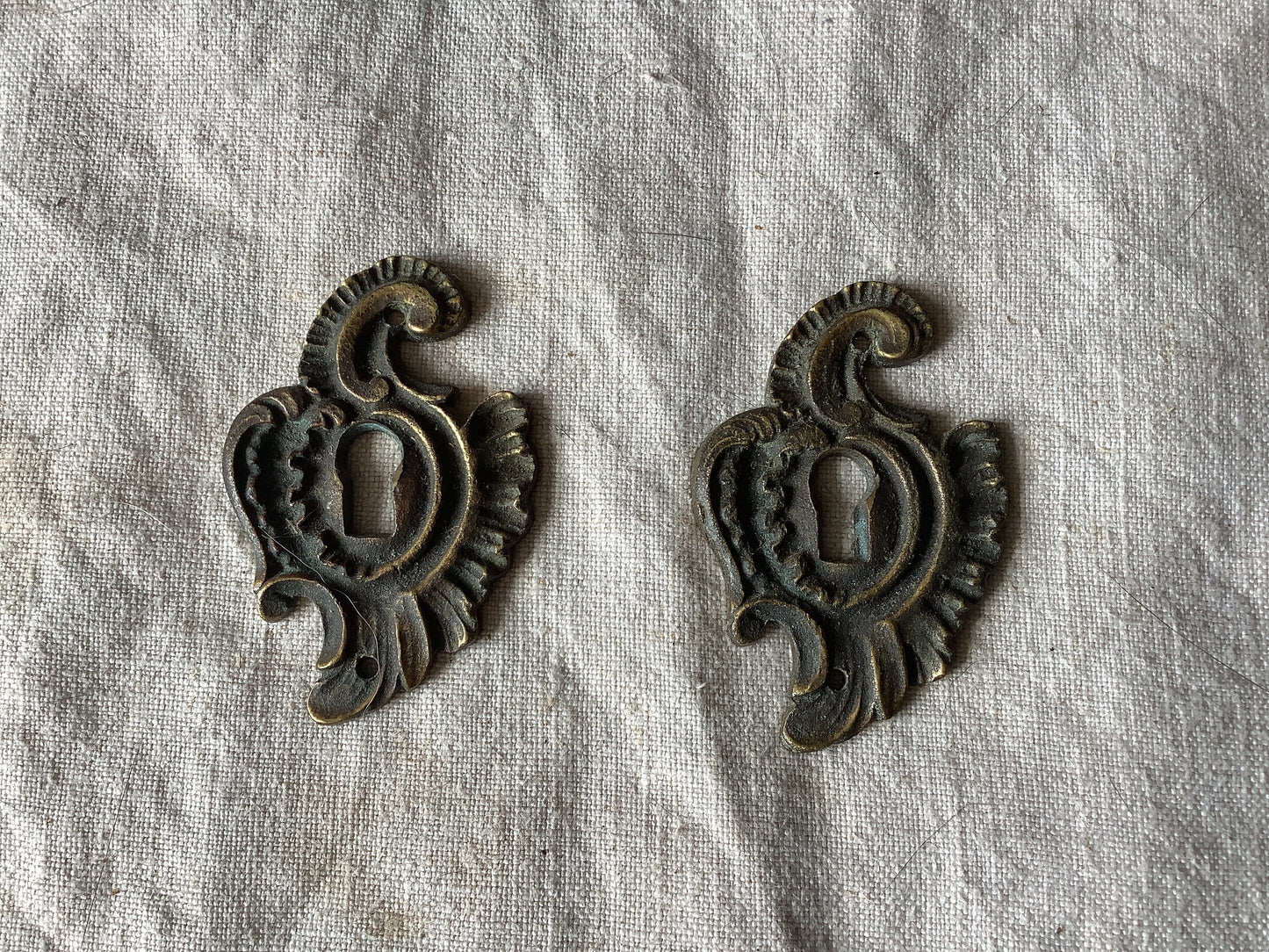 A set of Two matching Antique Brass Keyhole Cover made in France in the 1900s dark with patina