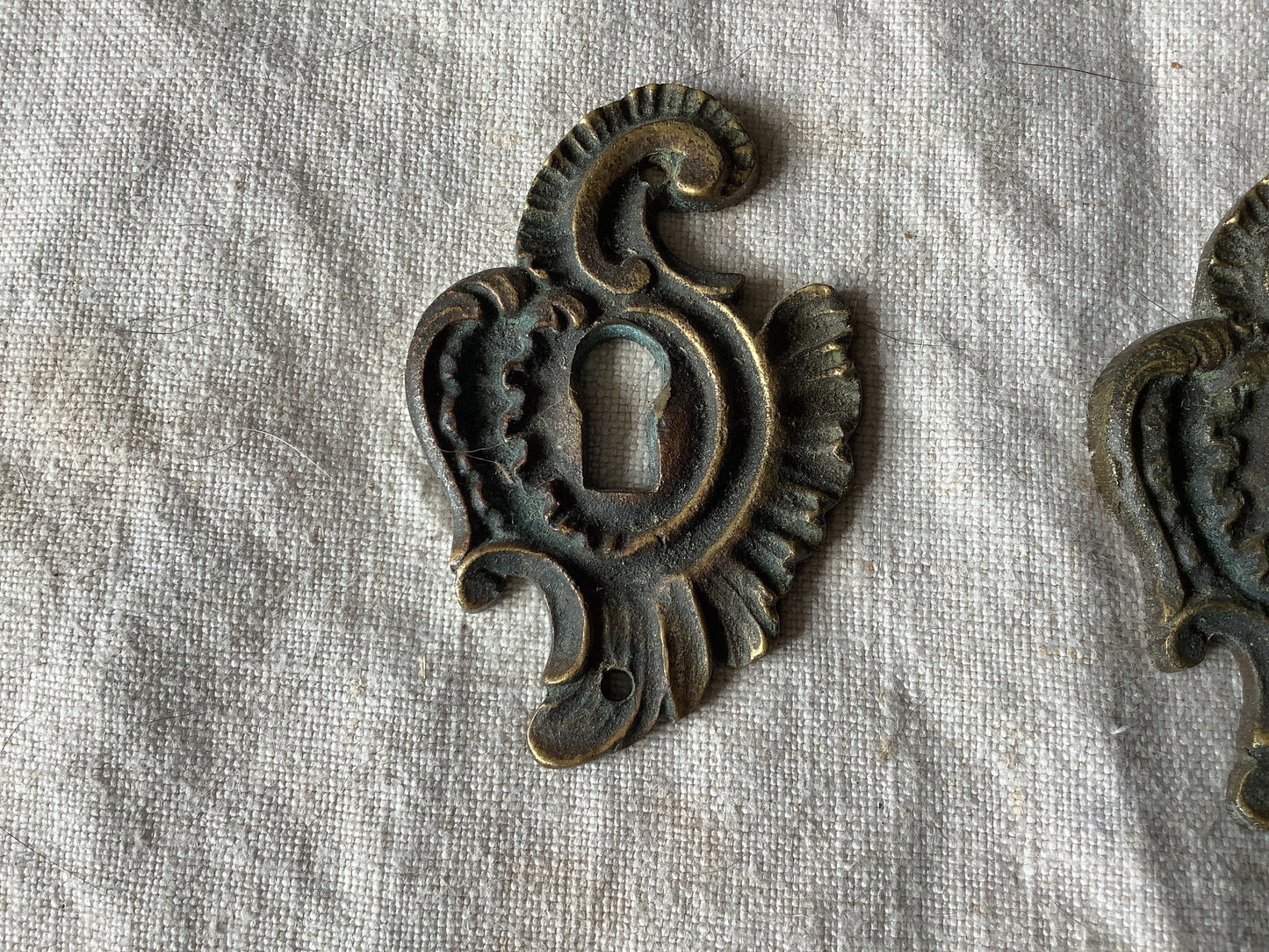 A set of Two matching Antique Brass Keyhole Cover made in France in the 1900s dark with patina