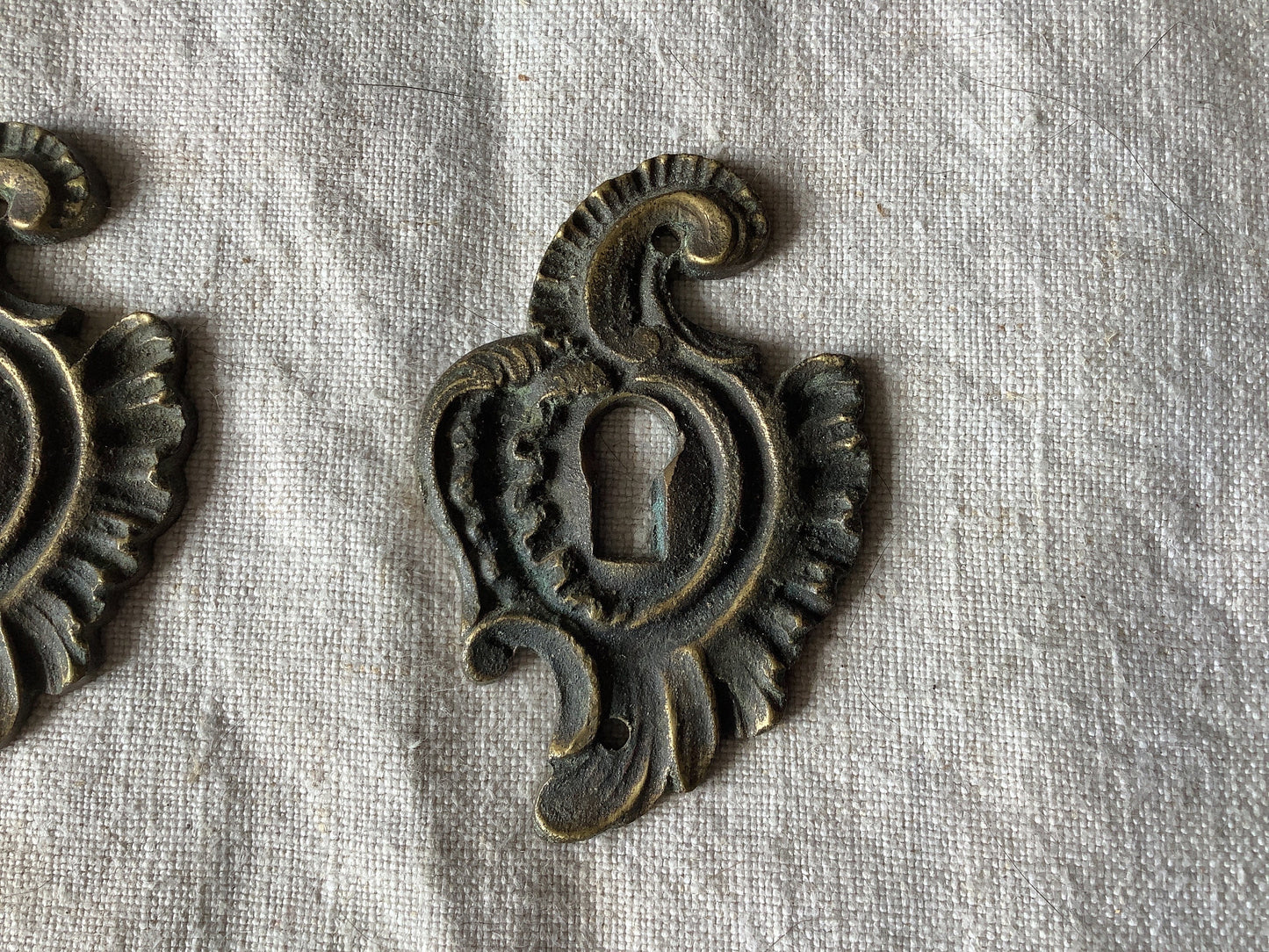 A set of Two matching Antique Brass Keyhole Cover made in France in the 1900s dark with patina