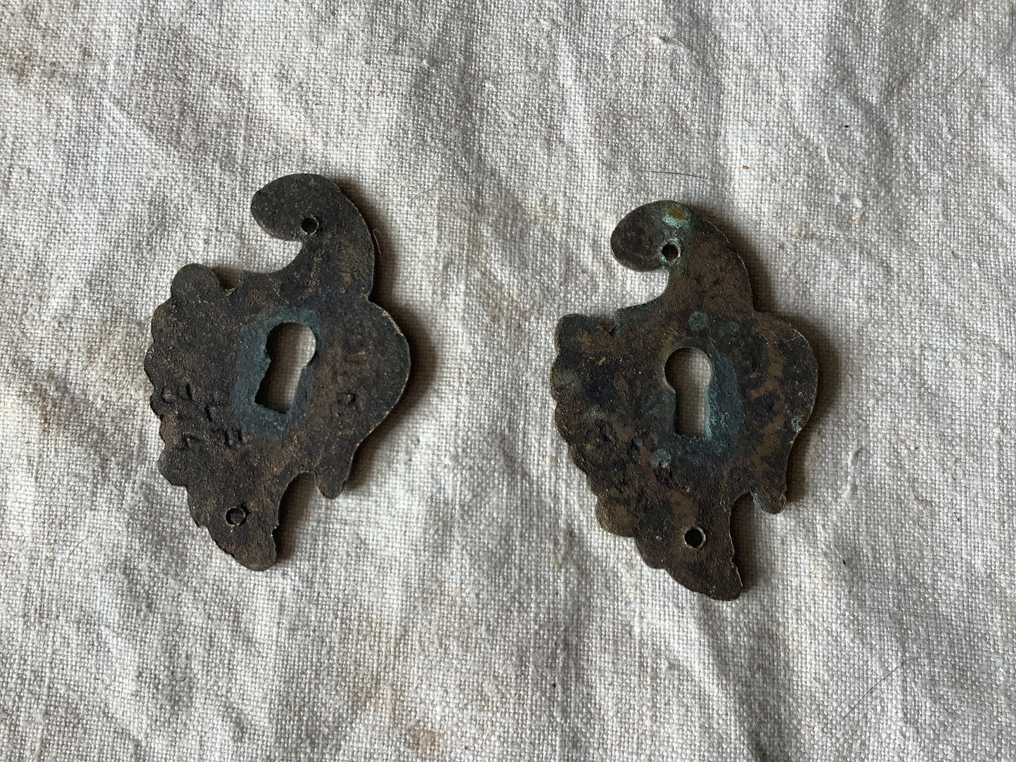 A set of Two matching Antique Brass Keyhole Cover made in France in the 1900s dark with patina