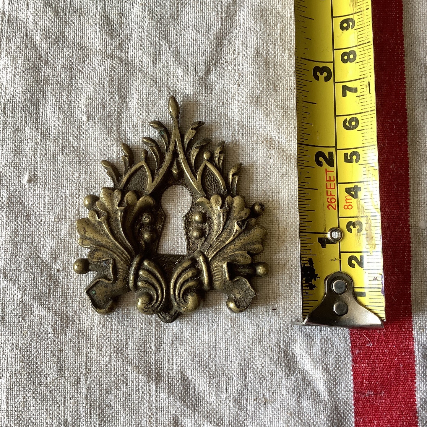 One Antique Brass Keyhole Cover made in France in the 1900s