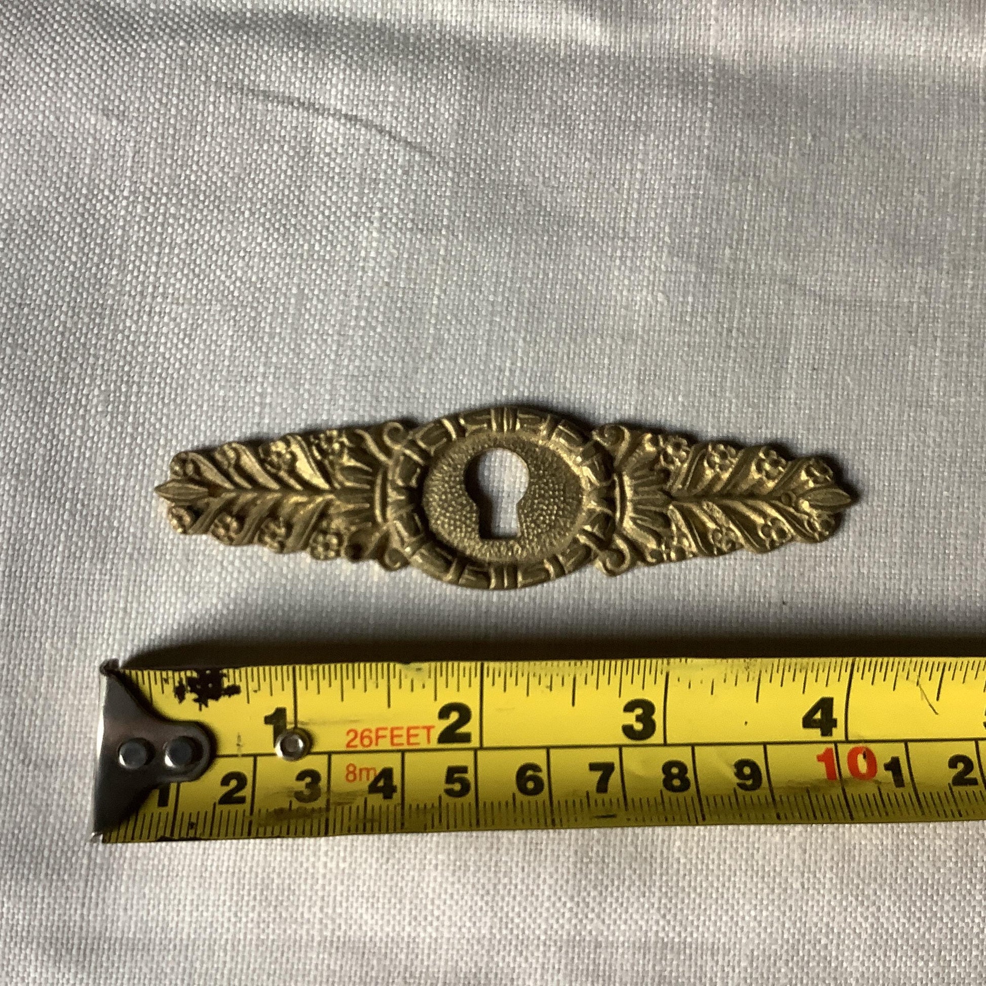 One Antique Brass Ormolu Keyhole Cover Escutcheon made in France in the 1900s