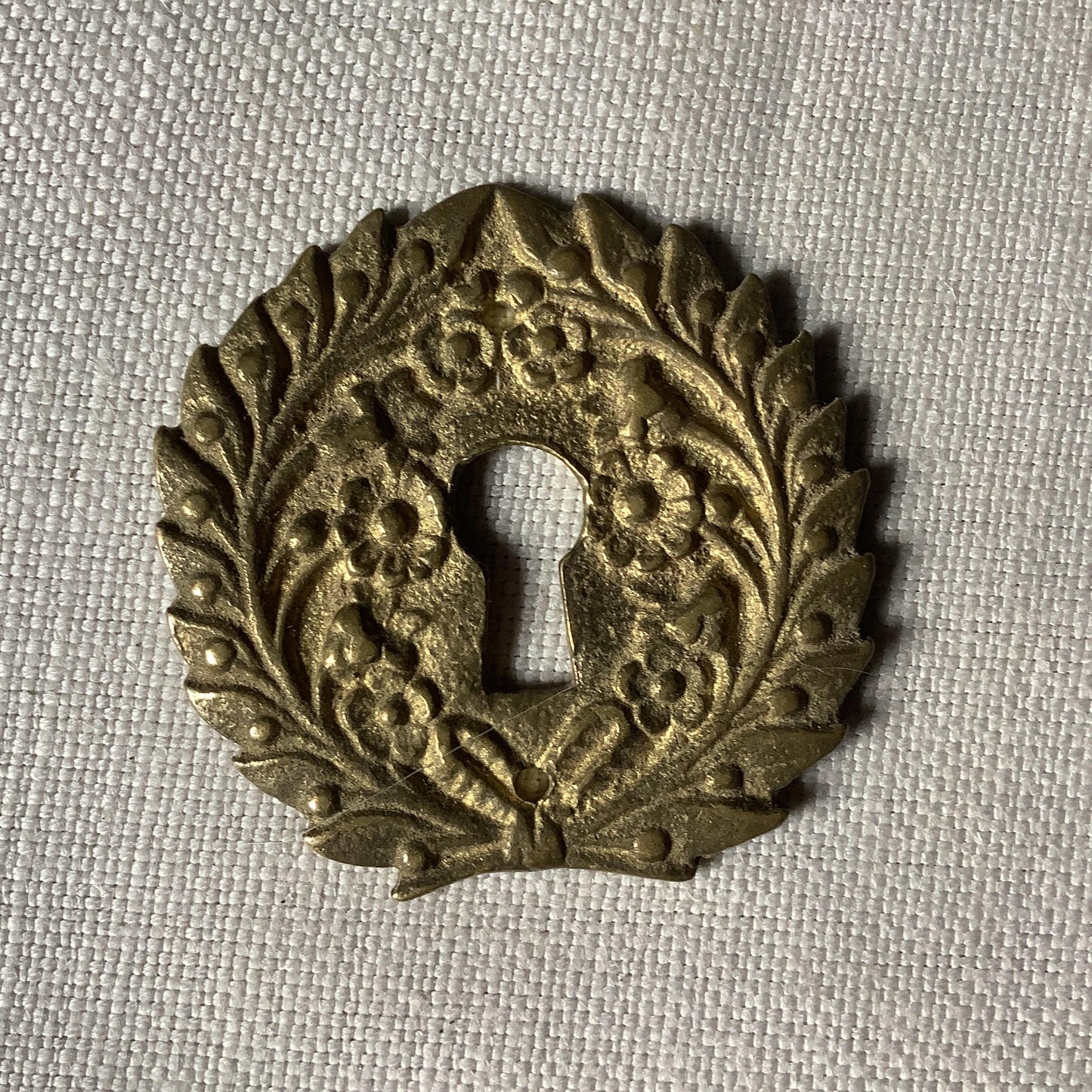 One Antique Brass Ormolu Keyhole Cover Escutcheon made in France in the 1900s elegant flower wreath