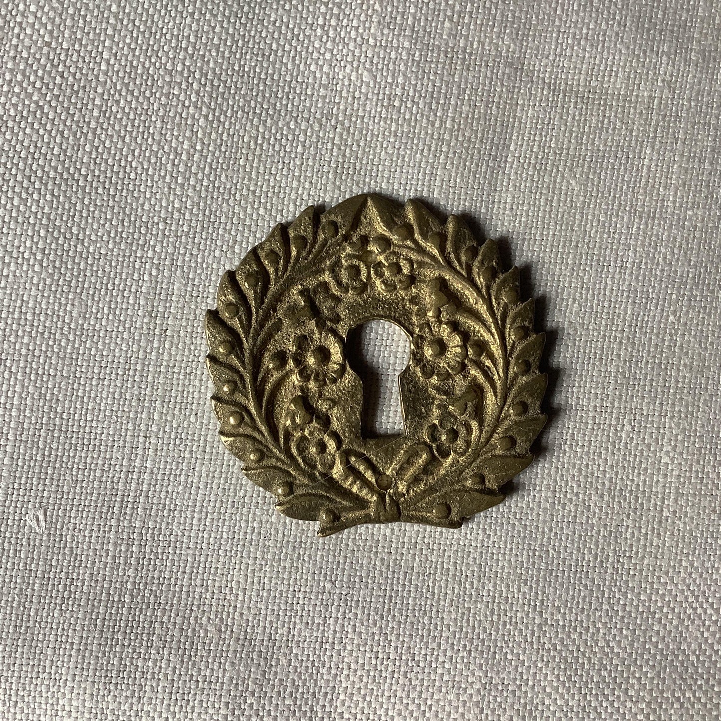 One Antique Brass Ormolu Keyhole Cover Escutcheon made in France in the 1900s elegant flower wreath