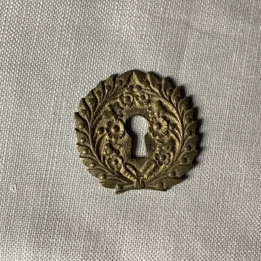 One Antique Brass Ormolu Keyhole Cover Escutcheon made in France in the 1900s elegant flower wreath