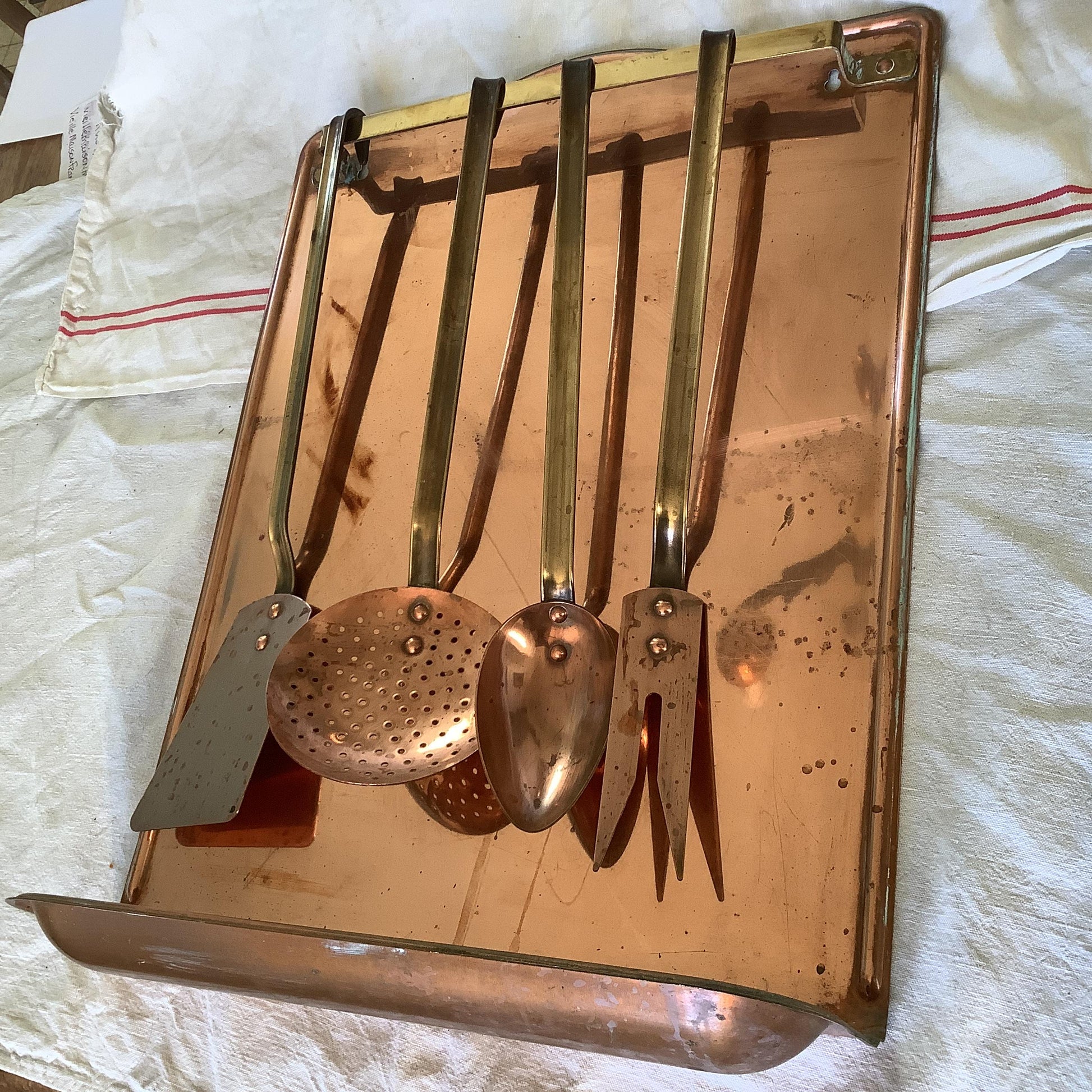 Vintage 1940s set of four copper cooking utensils, brass handles and copper rivets, display wall mounted drain stand made in France