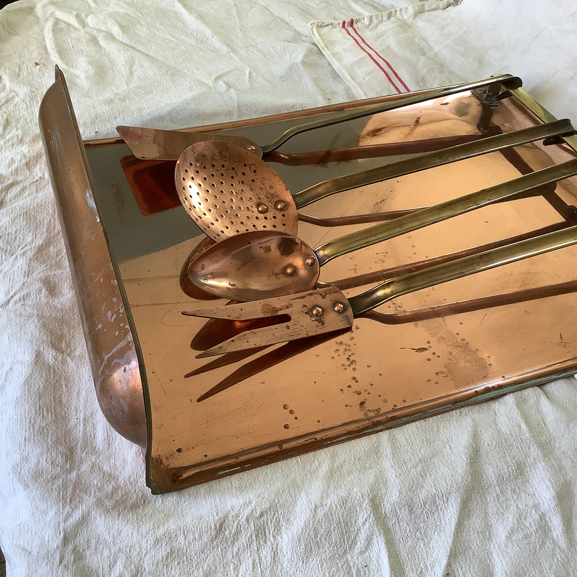 Vintage 1940s set of four copper cooking utensils, brass handles and copper rivets, display wall mounted drain stand made in France